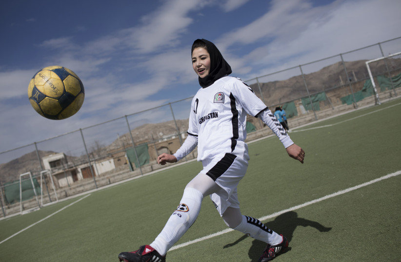 A female soccer player controls a ball during a training session at the Golab Trust Sport Complex in Kabul March 10, 2014 (photo credit: MORTEZA NIKOUBAZI/ REUTERS)