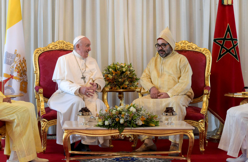 Pope Francis is received by Morocco's King Mohammed VI upon his arrival in the capital Rabat, Morocco, March 30, 2019 (photo credit: VATICAN MEDIA / REUTERS)
