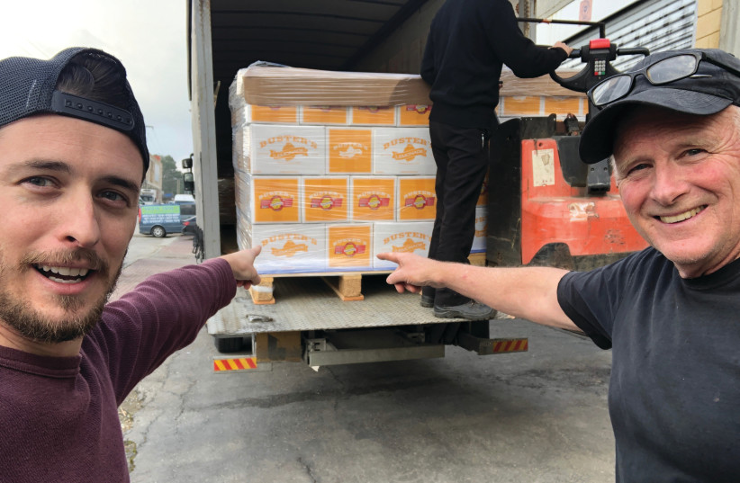 MATT NEILSON (left) and Denny Neilson with the first shipment of ciders and lemonades leaving for America (photo credit: Courtesy)