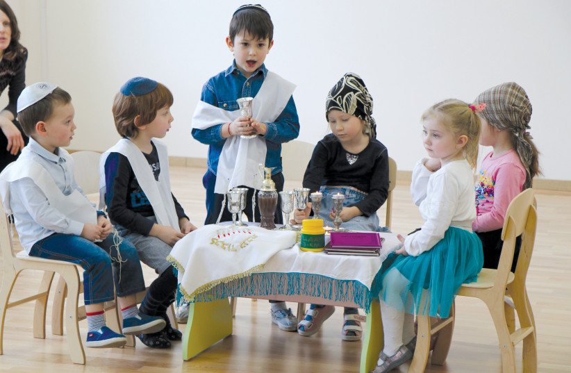 Pupils at the Simcha school in Kiev, Ukraine, perform a Shabbat dinner scene as part of their studies (photo credit: Courtesy)