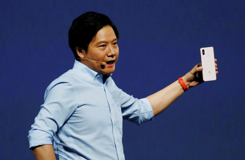 Xiaomi founder Lei Jun introduces the flagship Mi 8 during a product launch in Shenzhen, China May 31, 2018. (photo credit: BOBBY YIP/ REUTERS)