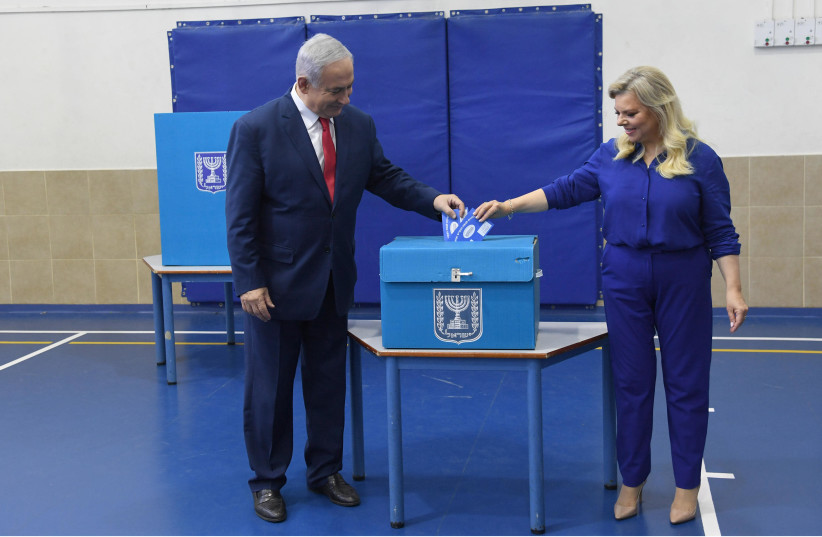 Prime Minister Benjamin Netanyahu and his wife Sara vote in Israel's elections on April 9, 2019 (photo credit: HAIM ZACH/GPO)