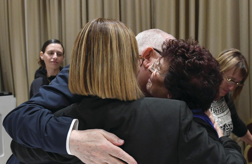 PRESIDENT REUVEN RIVLIN embraces Nili Oz (right) and Fania Oz-Salzberger (photo credit: Mark Neiman/GPO)