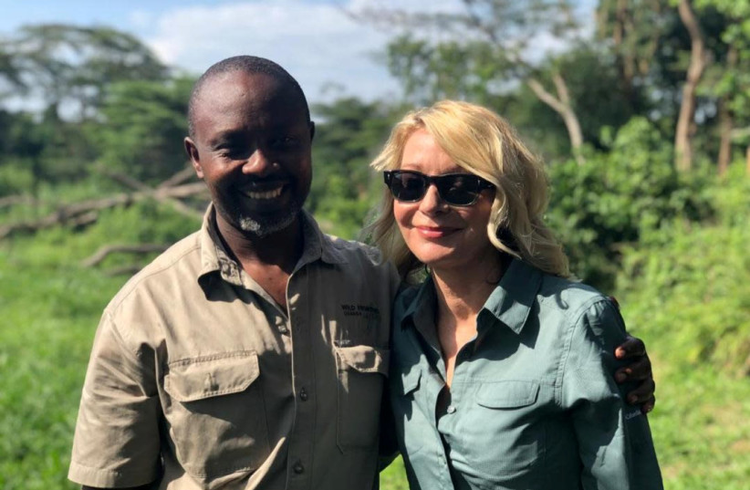 U.S. tourist Kimberly Sue Endicott poses with her guide, Jean Paul Mirenge in Uganda (photo credit: WILD FRONTIERS/VIA REUTERS)