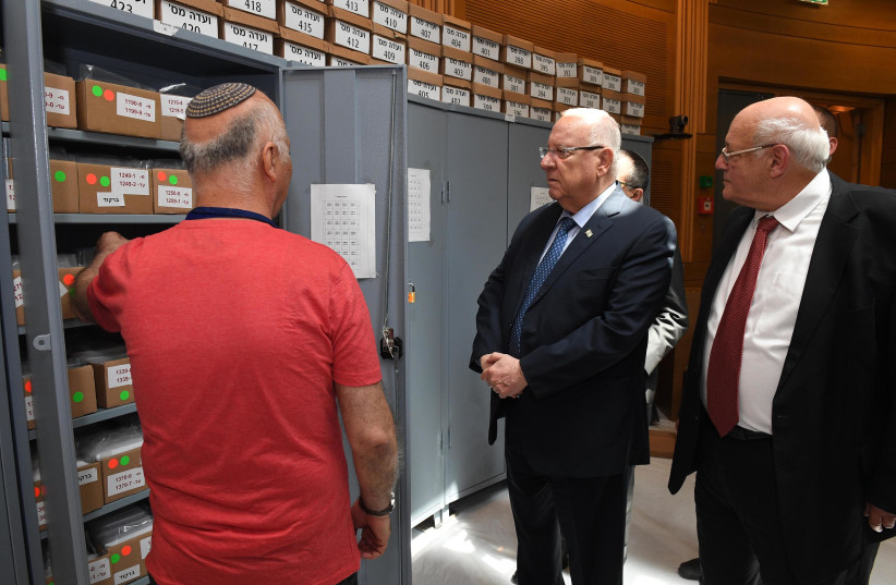 President Reuven Rivlin (C) and Central Elections Committee Chair Hanan Melcer (R) view ballots from the elections, April 10th, 2019 (photo credit: Mark Neiman/GPO)