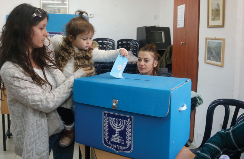 A woman votes in Jerusalem (photo credit: MARC ISRAEL SELLEM)