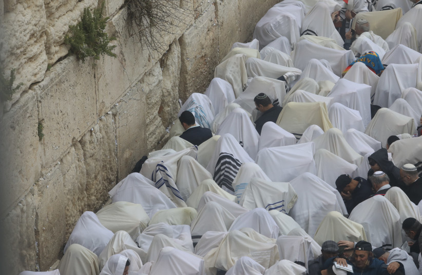 Birkat Kohainim, or priestly blessing, recited at the Western Wall on Passover, April 22, 2019 (photo credit: MARC ISRAEL SELLEM)
