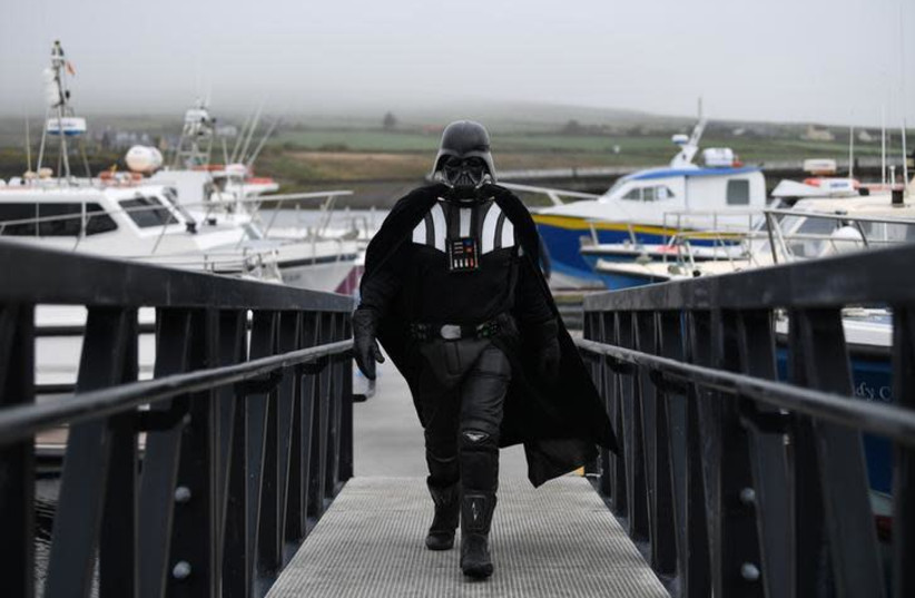 A Star Wars fan dressed in costume as Darth Vader (photo credit: REUTERS/CLODAGH KILCOYNE)