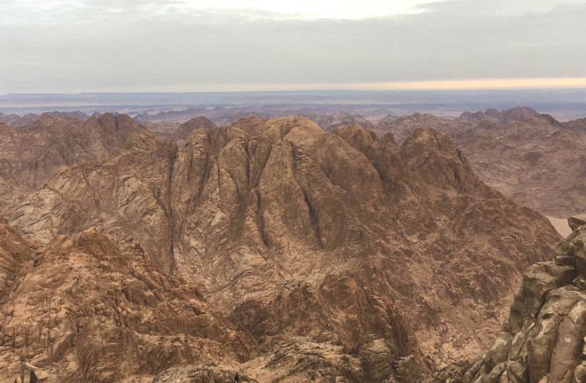 The top of Mt. Sinai at sunrise, overlooking a nearby mountain range (photo credit: JOHN COLIN MARSTON / SAINT CATHERINE)