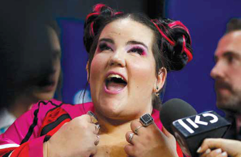 Israel’s Netta reacts after winning the Grand Final of Eurovision Song Contest 2018 at the Altice Arena hall in Lisbon, Portugal, last May. (credit: PEDRO NUNES/REUTERS)