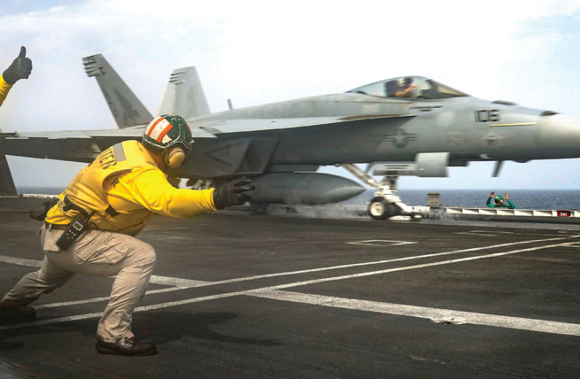 AN F/A-18E Super Hornet is launched from the flight deck of the US Navy Nimitz-class aircraft carrier ‘USS Abraham Lincoln,’ in the Arabian Sea on May 16. (credit: REUTERS)