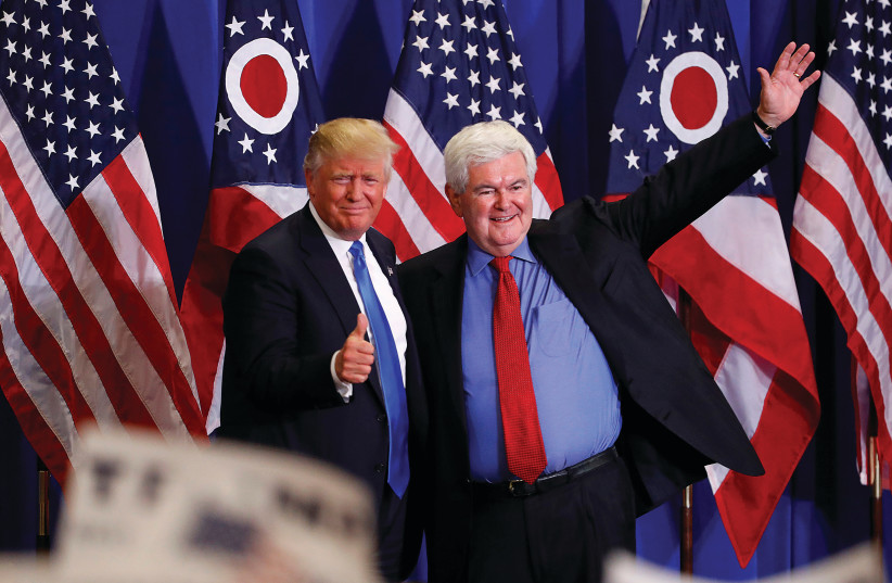 FORMER US SPEAKER of the House Newt Gingrich greets then-US Republican presidential candidate Donald Trump at a rally in Cincinnati, Ohio, in 2016. (Aaron P. Bernstein/Reuters) (photo credit: YONATAN SINDEL/FLASH 90)