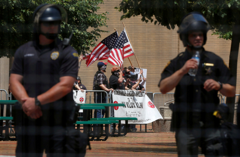 Members of the white nationalist group the Honorable Sacred Knights of the Ku Klux Klan hold a rally in Dayton, Ohio, U.S., May 25, 2019 (photo credit: JIM URQUHART/REUTERS)