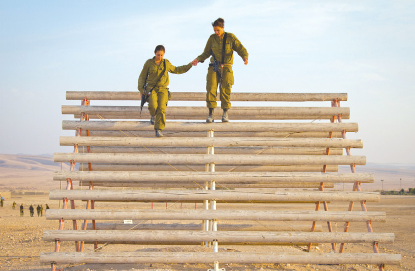 A SELECTION of photos of women in the IDF from inside ‘Women on the Front Lines.’ (photo credit: DEBBIE ZIMELMAN)