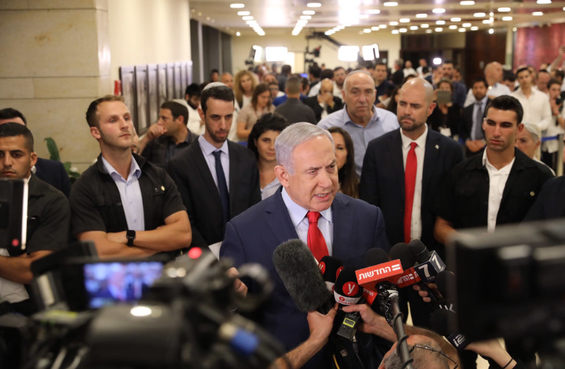Prime Minister Benjamin Netanyahu speaks with the press following the vote for Knesset dispersal. (photo credit: MARC ISRAEL SELLEM)