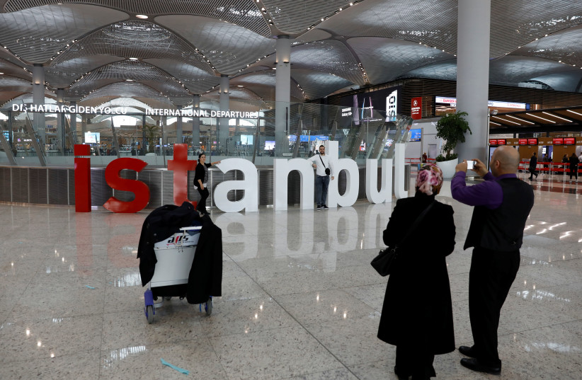 Passengers take photos at the city's new Istanbul Airport in Istanbul, Turkey (photo credit: UMIT BEKTAS / REUTERS)