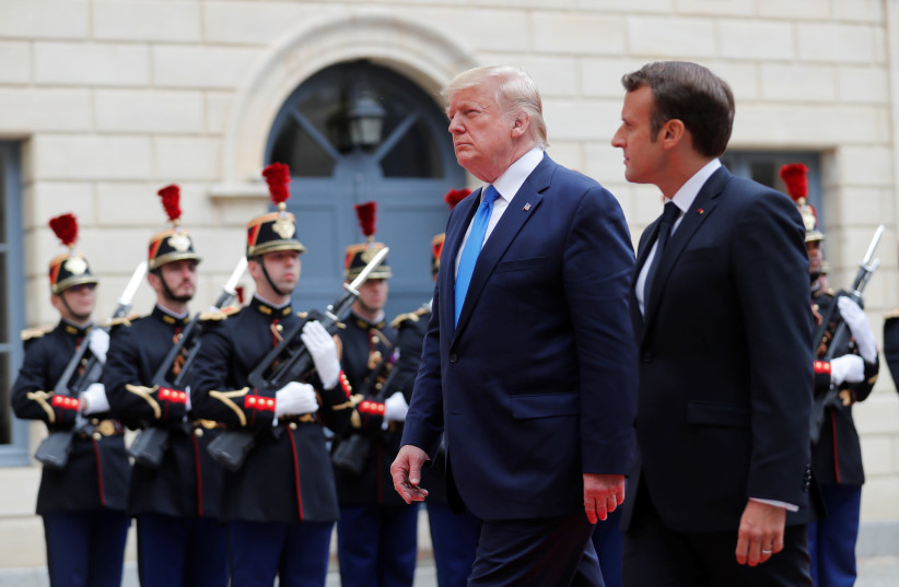 French President Emmanuel Macron and U.S. President Donald Trump arrive for bilateral talks in Caen, Normandy France. (photo credit: CARLOS BARRIA / REUTERS)