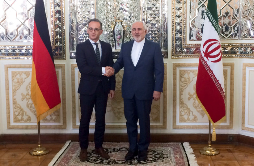Iranian Foreign Minister, Mohammad Javad Zarif shakes hands with his German counterpart Heiko Maas after their meeting in Teheran (photo credit: REUTERS/SABINE SEIBOLD)