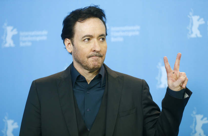 Actor John Cusack poses during a photocall to promote the movie 'Chi-Raq' at the 66th Berlinale International Film Festival in Berlin, Germany February 16, 2016 (photo credit: REUTERS/HANNIBAL HANSCHKE)