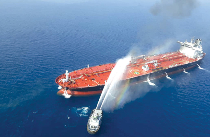 AN IRANIAN NAVY boat tackles a fire on an oil tanker after it was attacked in the Gulf of Oman last week. (credit: TASNIM NEWS AGENCY)