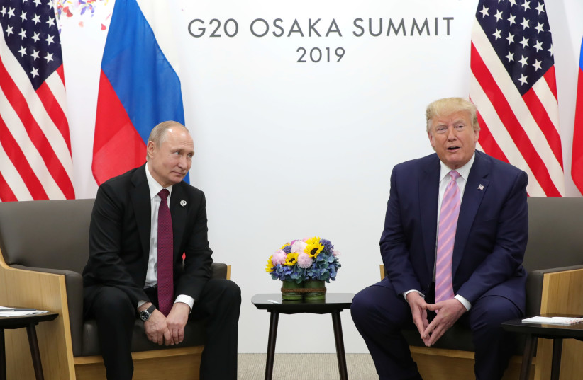 Russia's President Vladimir Putin and U.S. President Donald Trump attend a meeting on the sidelines of the G20 summit in Osaka, Japan June 28, 2019 (photo credit: REUTERS)