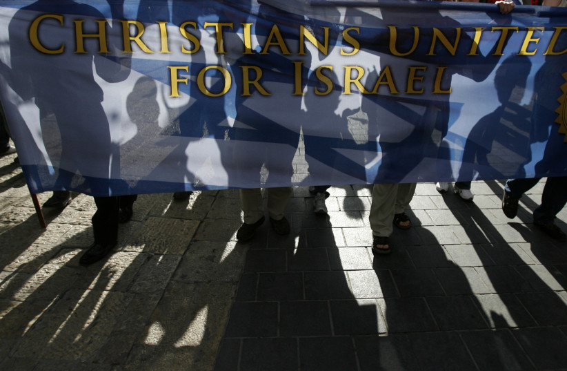 Christian demonstrators carry a banner during a march in Jerusalem (photo credit: ELIANA APONTE/REUTERS)
