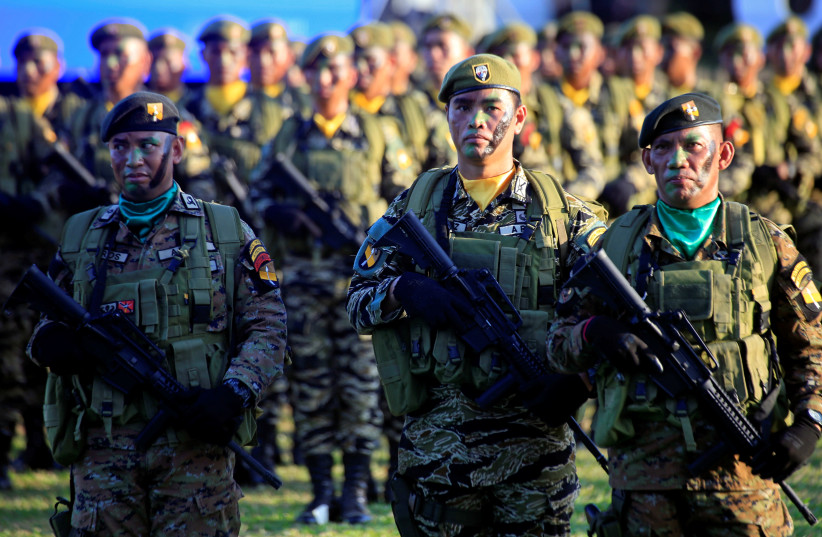 Soldiers holding their weapons stand on attention during the 121st anniversary celebration of the Philippine Army at Taguig city, Metro Manila, Philippines March 20, 2018 (photo credit: ROMEO RANOCO/REUTERS)
