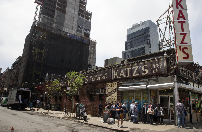 People stand in line at Katz's Delicatessen, the famous deli founded in 1888, in New York's lower East Side (photo credit: BRENDAN MCDERMID/REUTERS)