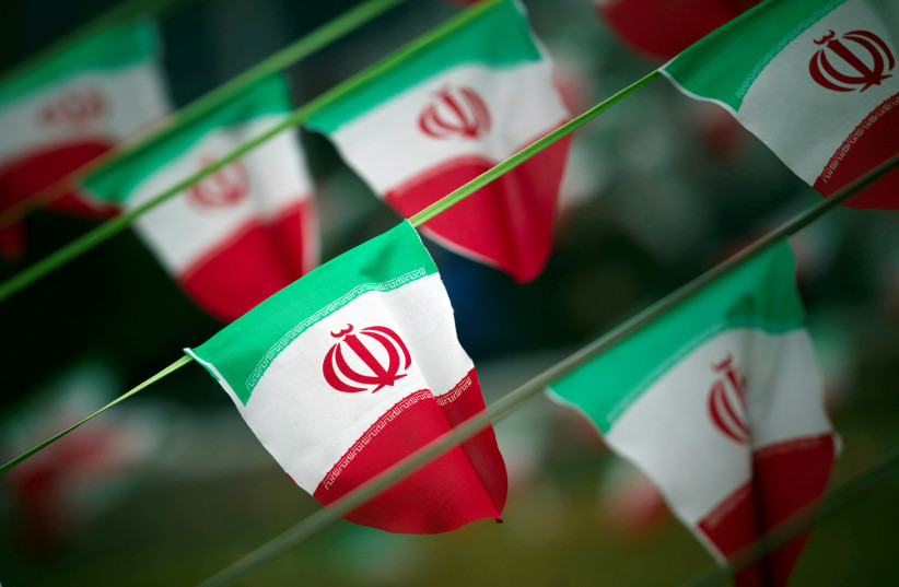 Iran's national flags are seen on a square in Tehran (photo credit: MORTEZA NIKOUBAZI/ REUTERS)