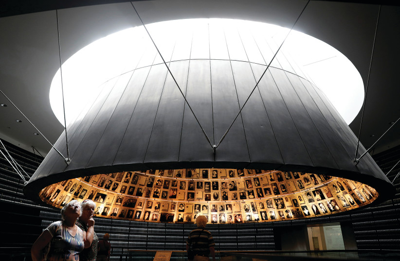 PEOPLE VISIT the Hall of Names at the Yad Vashem World Holocaust Remembrance Center in May.  (photo credit: RONEN ZVULUN / REUTERS)