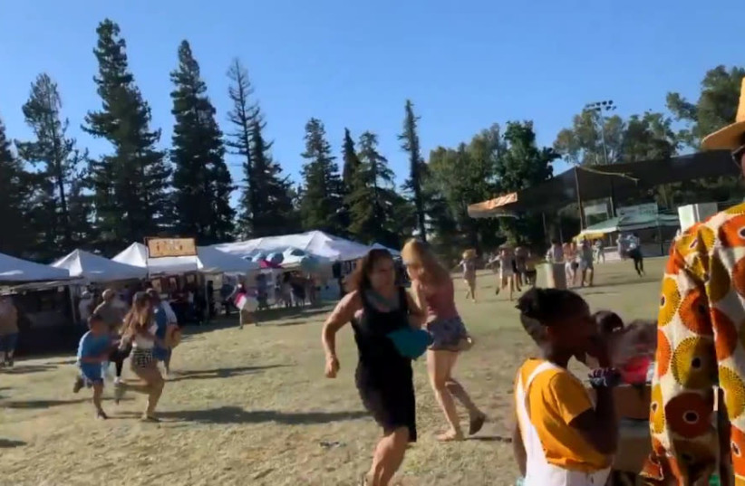 Social media video grab of people running away as an active shooter was reported at the Gilroy Garlic Festival, south of San Jose, California (photo credit: REUTERS)