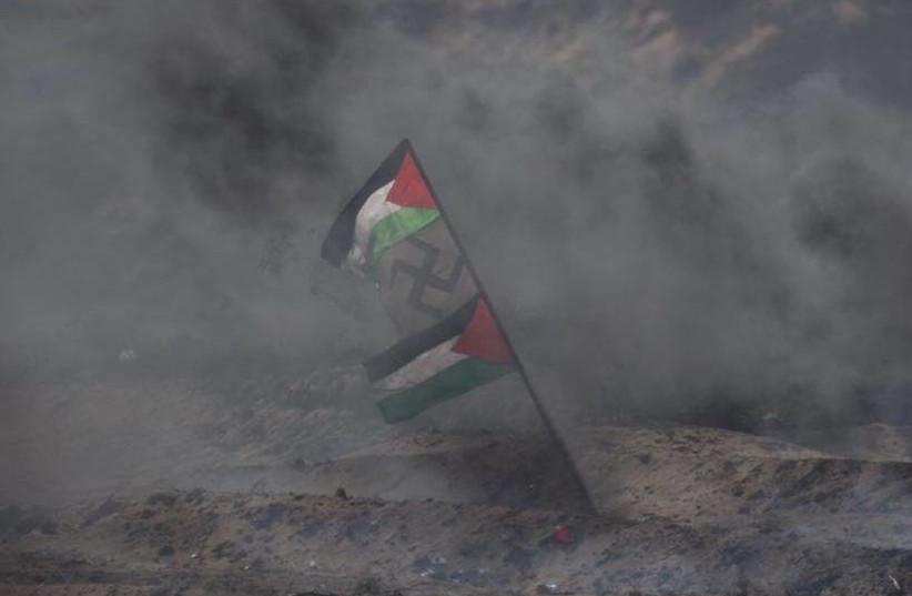 Swastika hung next to Palestinian flag on Gaza border fence during March of Return June, 2018 (photo credit: IDF SPOKESPERSON'S UNIT)