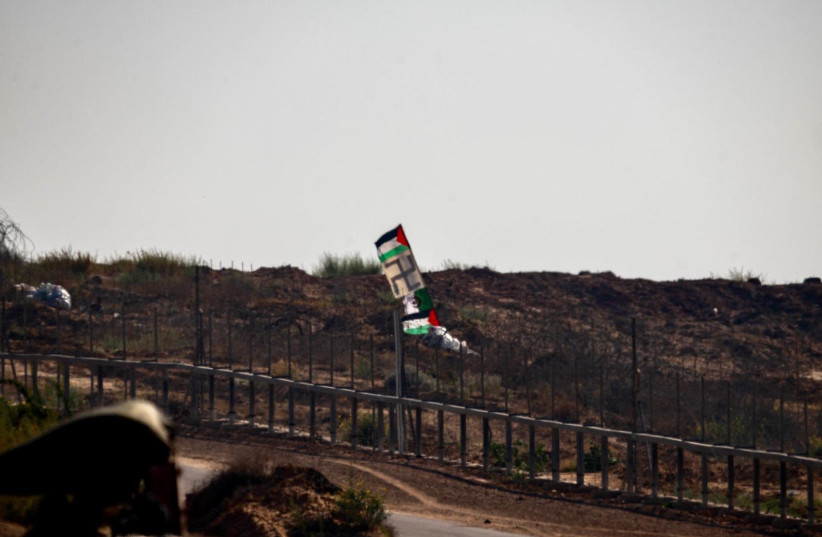 A Swastika flag flies alongside a Palestinian flag near the border fence in Gaza (photo credit: IDF)