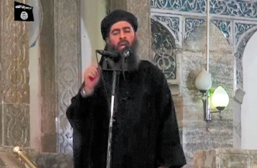 Still image taken from video of a man purported to be Islamic State leader Abu Bakr al-Baghdadi making what would be his first public appearance in Mosul in 2014. (photo credit: REUTERS)