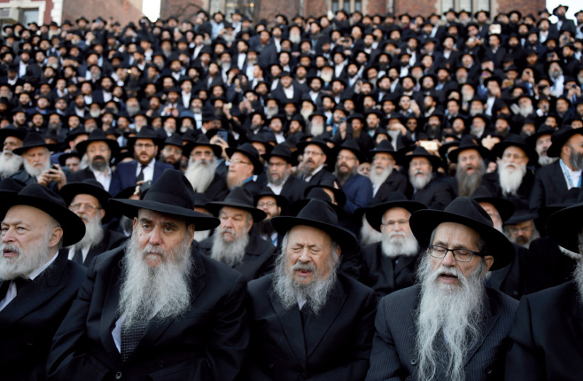 Chabad rabbis sing ‘Ani Ma’amin’ in front of the movement’s world headquarters in Brooklyn (photo credit: MARK KAUZLARICH/REUTERS)