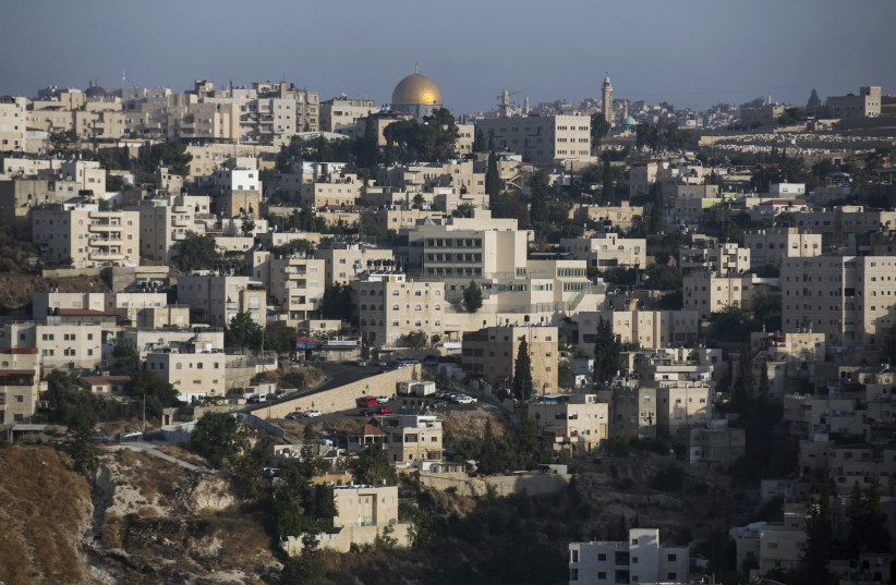 The Arab East Jerusalem neighbourhood of Ras al-Amud is seen in front of the Dome of the Rock (credit: BAZ RATNER/REUTERS)