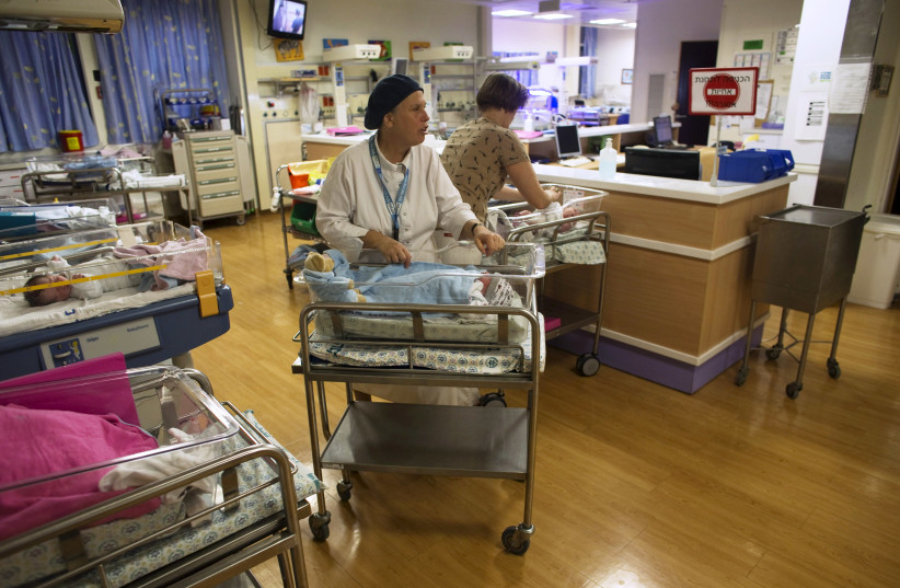 Nurses take care of newborn babies at a nursery in Hadassah Ein Kerem Medical Center in Jerusalem (photo credit: REUTERS/Ronen Zvulun)