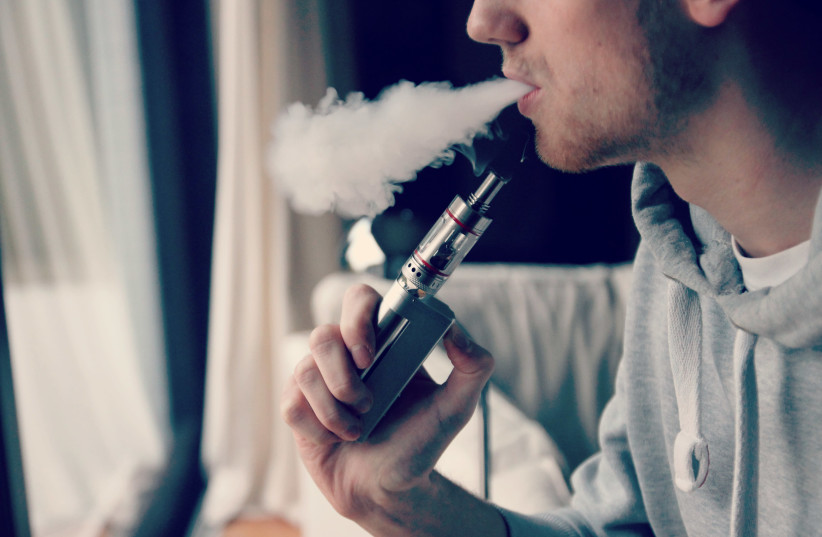 A person is seen smoking an e-cigarette (credit: Wikimedia Commons)