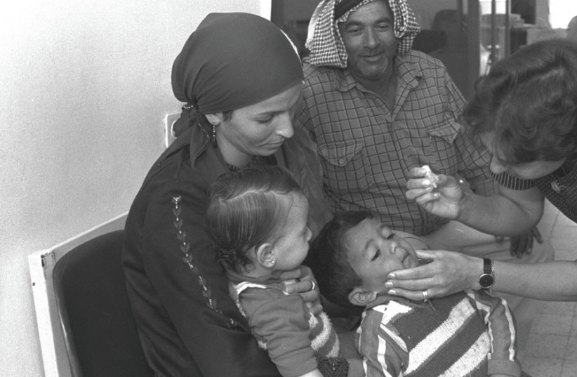 ARAB RESIDENTS of Jerusalem take their children to get the polio vaccine at a Tipat Halav clinic in the Armon Hanatziv neighborhood in 1988. (photo credit: AYALON MAGGI/GPO)