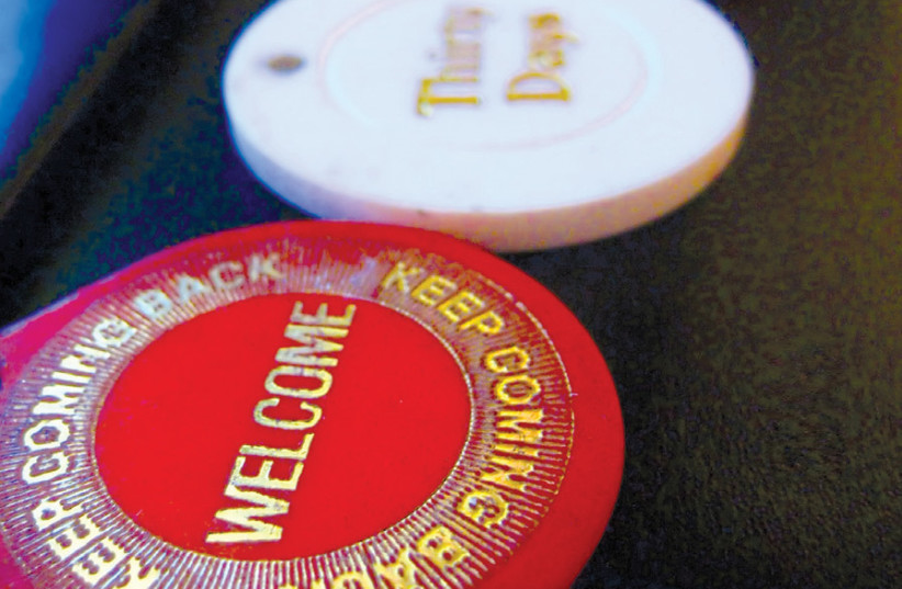SOBRIETY COINS given to Alcoholics Anonymous members representing the amount of time they have remained sober. (photo credit: CHRIS YARZAB/FLICKR)