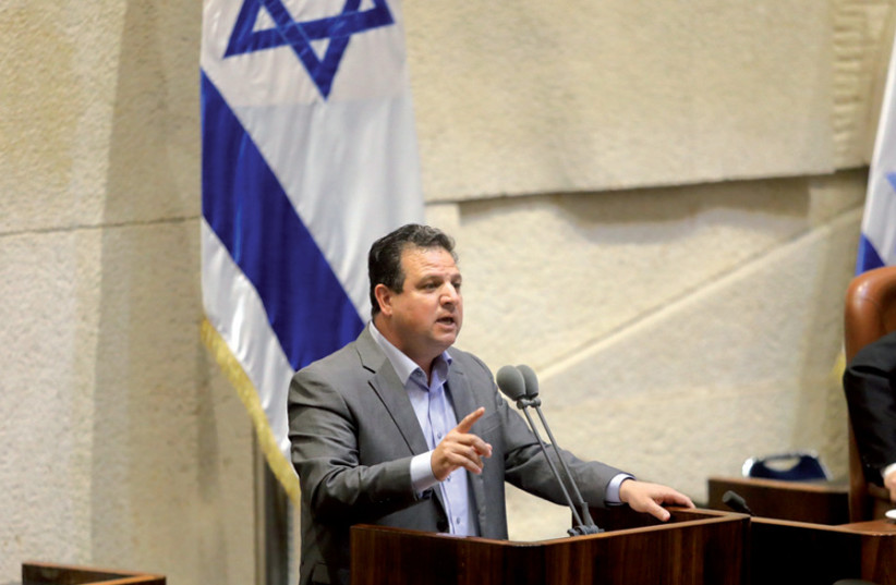 Joint List leader Ayman Odeh addresses the Knesset: Odeh has suggested, for the first time, that Israeli Arabs would be willing to join a government coalition (credit: MARC ISRAEL SELLEM)