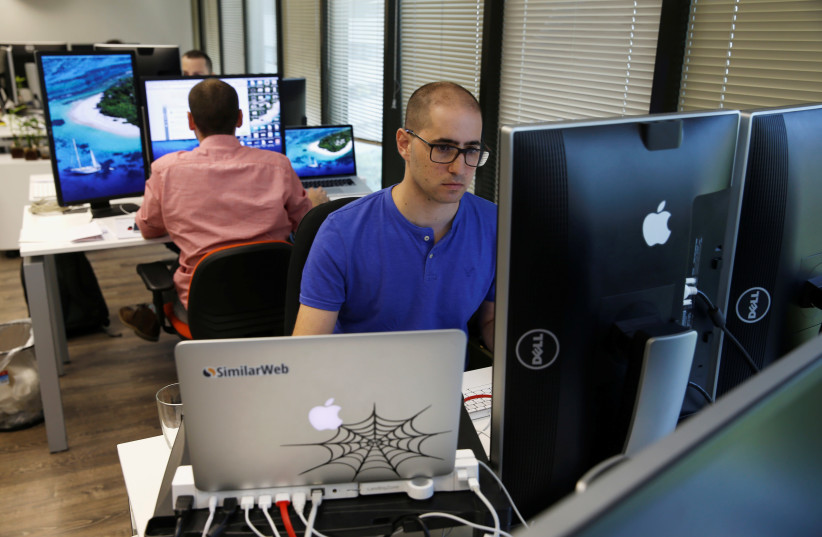 An employee works at Internet data firm SimilarWeb at their offices in Tel Aviv, Israel July 4, 2016 (photo credit: REUTERS)