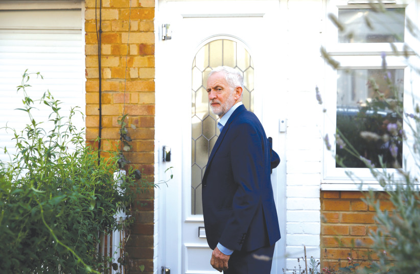 BRITAIN’S OPPOSITION Labour Party leader Jeremy Corbyn leaves his home in London yesterday.  (photo credit: HENRY NICHOLLS/REUTERS)