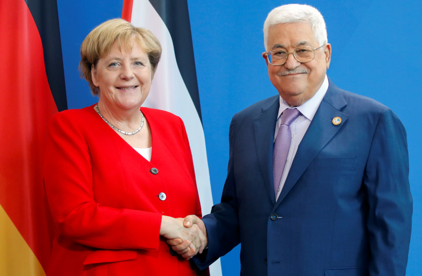 German Chancellor Angela Merkel and Palestinian President Mahmoud Abbas shake hands during a news conference ahead of their meeting in Berlin, Germany, August 29, 2019. (photo credit: AXEL SCHMIDT/REUTERS)