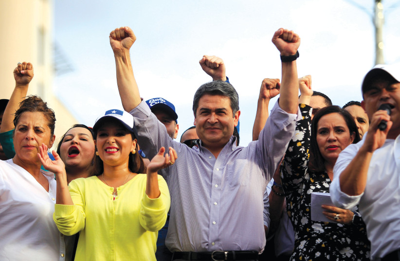 HONDURAN PRESIDENT Juan Orlando Hernández rallies with supporters outside the Presidential House.  (credit: JORGE CABRERA/ REUTERS)