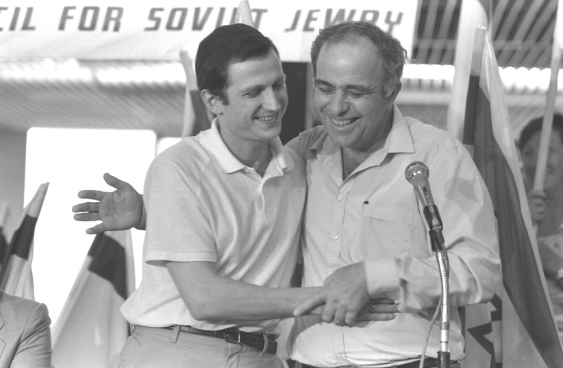 YULI EDELSTEIN (left) is embraced by absorption minister Ya’acov Tzur after arriving at Ben-Gurion Airport in 1987 (photo credit: NATI HARNIK/GPO)
