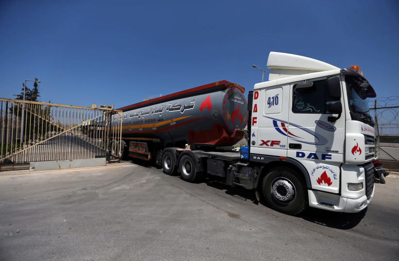 A fuel tanker leaves the Gaza power plant in the central Gaza Strip August 26, 2019 (photo credit: REUTERS/IBRAHEEM ABU MUSTAFA)