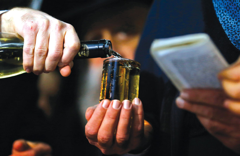 A GLASS of wine is poured during a Jewish wedding ceremony.  (photo credit: REUTERS)