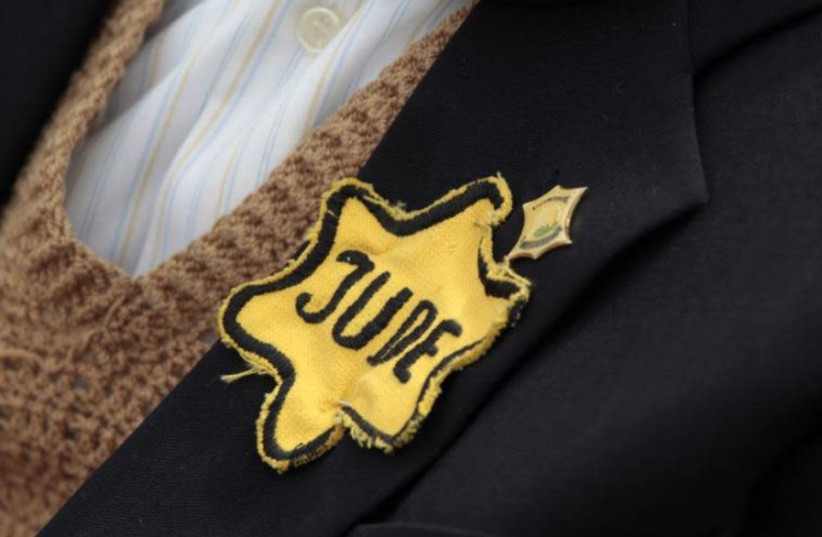 Polish born Mordechai Fox, an 89-year-old Holocaust survivor, wears a yellow Star of David on his jacket during a ceremony marking Holocaust Remembrance Day (credit: REUTERS)