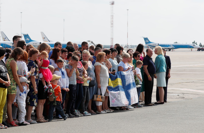 Relatives of Ukrainian prisoners, included in the Russia-Ukraine prisoner swap, wait for their arrival at Borispil International Airport outside Kiev, Ukraine September 7, 2019 (photo credit: GLEB GARANICH/REUTERS)